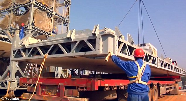 Steady: The sections built off the site are maneuvered into position by men who worked until 10pm every night